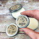 Grass-fed Tallow Salve, 1/2 Ounce Tin, Held in Fingers to Show Scale
